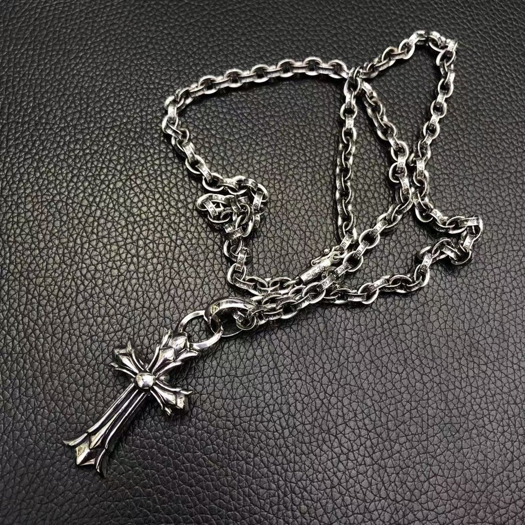 Silver-tone cross pendant necklace with layered chain links