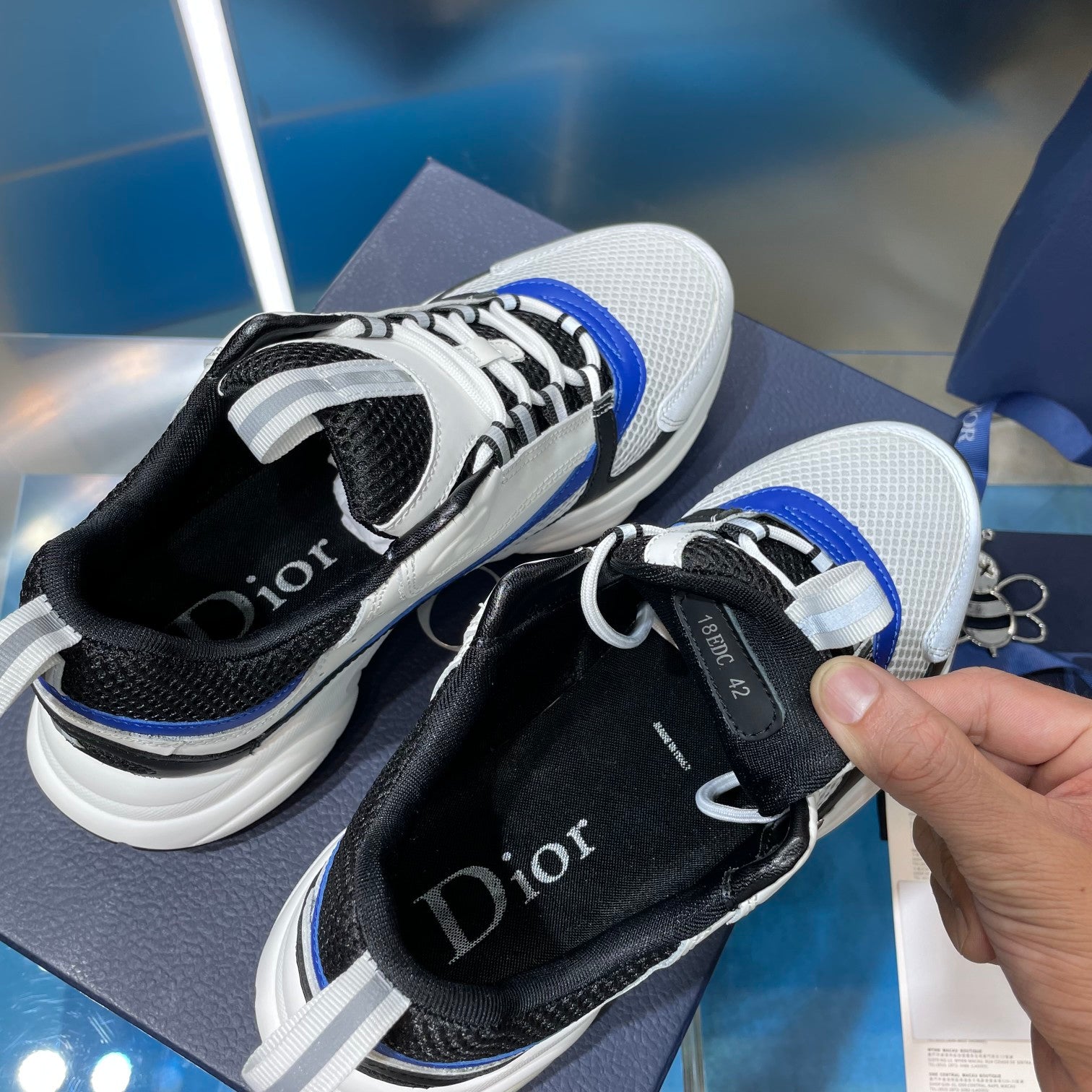 Dior unisex sneakers, black tongue detail with blue stripe and white mesh upper