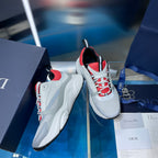 White sneakers with red mesh details and black laces, shown from the side.