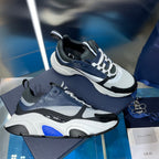 Dior unisex chunky sneakers in navy, white, and light gray with mesh panels