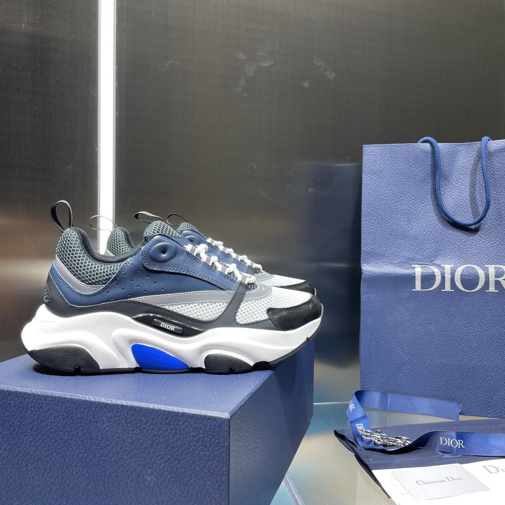 Navy and white Dior chunky sneakers with patterned upper and blue accents