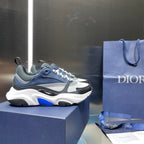 Navy and white Dior chunky sneakers with patterned upper and blue accents