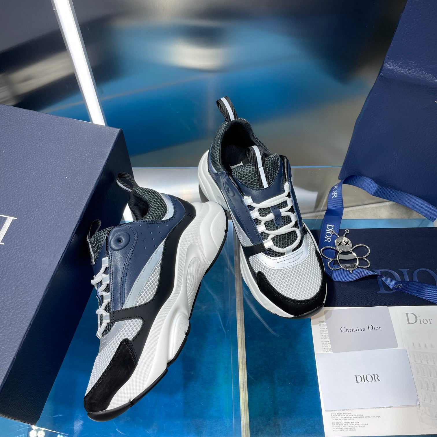Navy and white lace-up Dior sneakers with mesh panels and thick sole