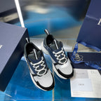 Pair of white-and-navy Dior sneakers with textured uppers and lace-up design
