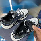 Dior sneakers with black heel, light gray toe, and lace-up knit upper