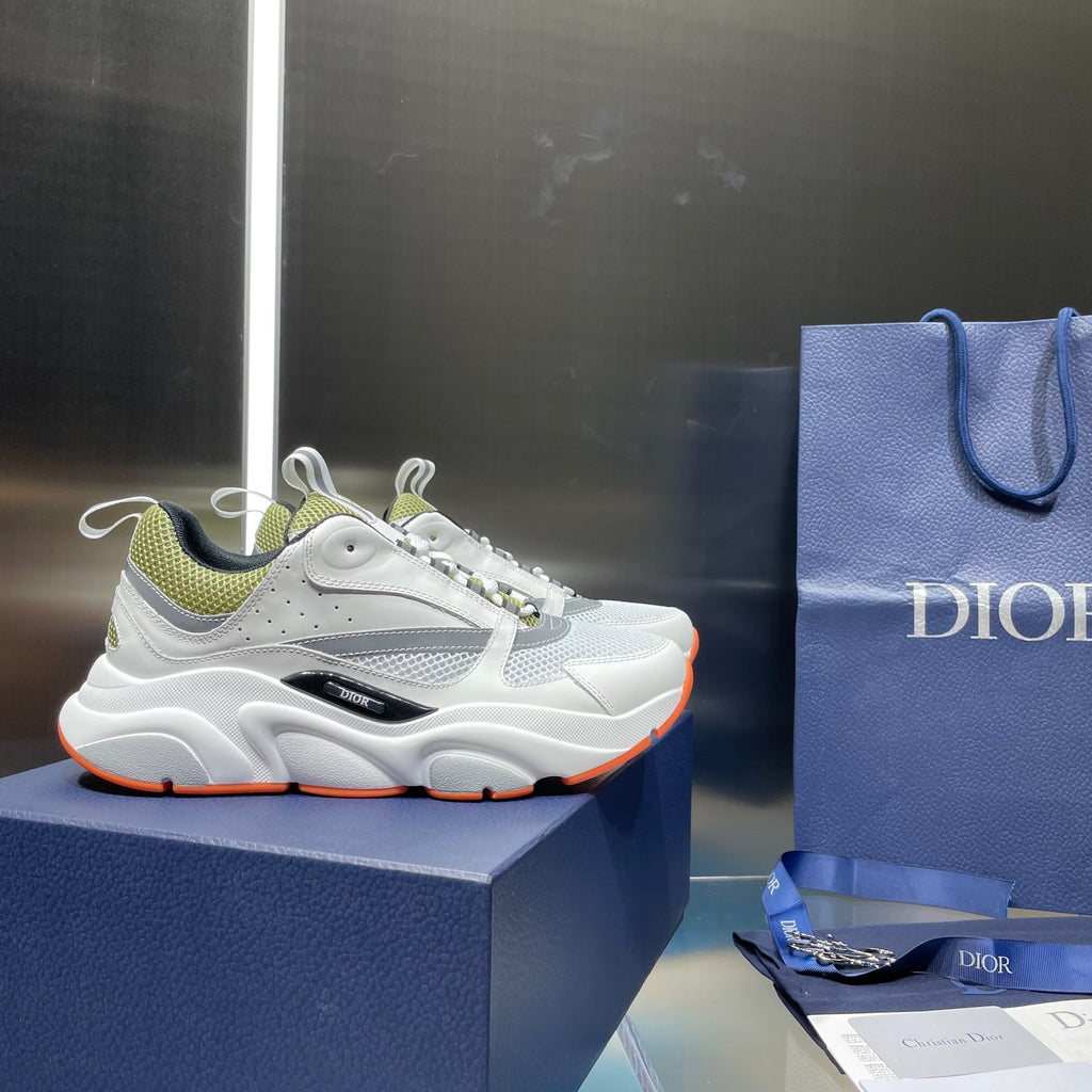 White and neon green lace-up sneakers on a blue box, cushioned sole