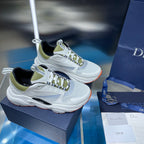 Pair of white lace-up sneakers with neon green collar and black logo detail