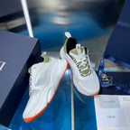 White lace-up sneakers with neon green lining and orange outsole edge