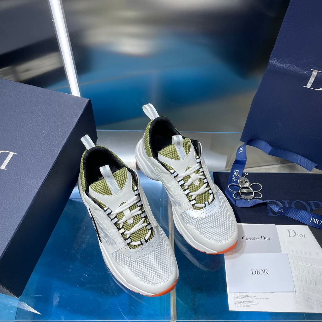 Two white sneakers with neon green accents and black lining, on display