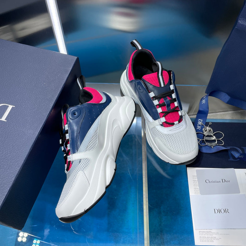 White and navy lace-up sneakers with bright pink collar and plaid laces