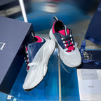 White and navy lace-up sneakers with bright pink collar and plaid laces