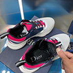 Sneakers with white mesh toe, navy panels, bright pink laces and Dior logo