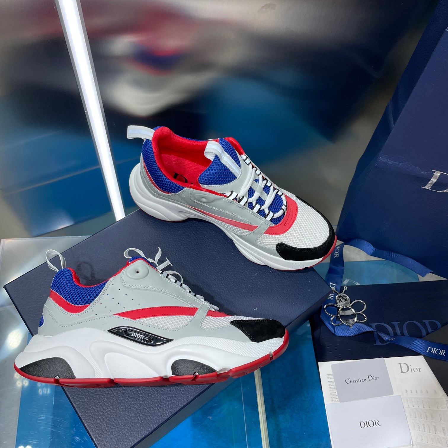 Dior unisex sneakers, white upper with blue and red panels, lace-up front