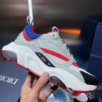 Dior unisex sneakers, close-up side view with red blue stripe and black detail