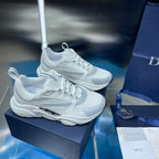 Pair of white lace-up sneakers with textured midsole and mesh panels