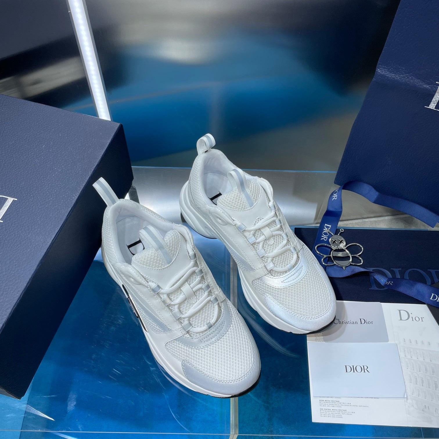 Pair of white lace-up sneakers with raised sole and padded tongue