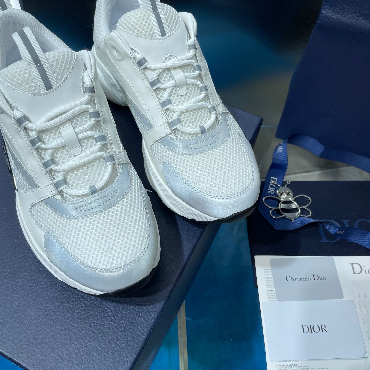 Close-up of white lace-up sneakers with mesh uppers and chunky soles