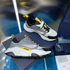 Unisex chunky sneaker, light gray upper with black panels and yellow lace accents
