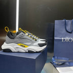 Unisex chunky sneaker on box, gray and black upper with yellow lace trim