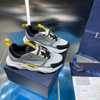 Pair of unisex chunky sneakers, gray mesh and black panels with yellow laces