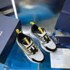 Pair of unisex sneakers, gray and black uppers with yellow lace accents, side view