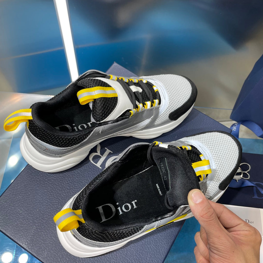 Unisex sneakers with black tongue, gray panels, yellow laces and white midsoles
