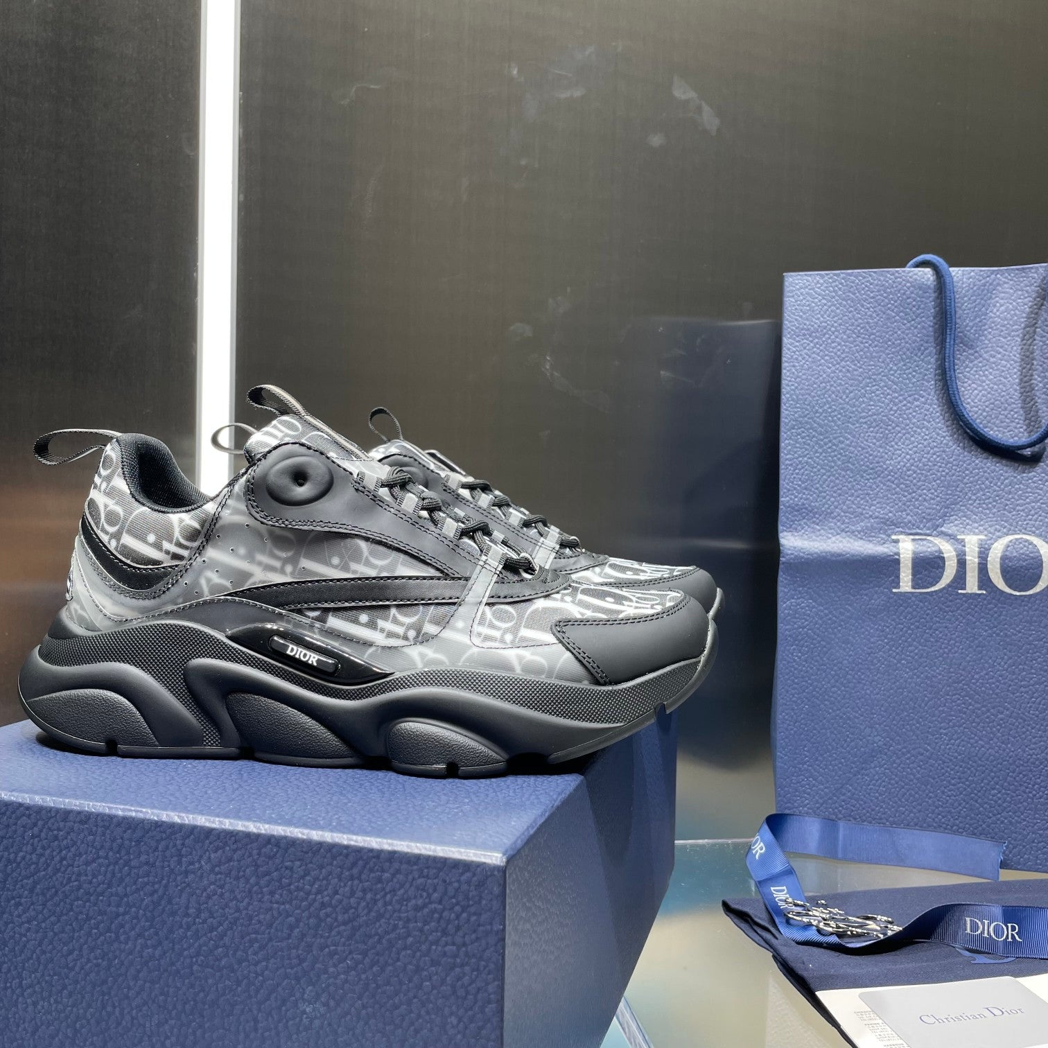 Low-profile lace-up sneakers with silver logo-print upper and dark rubber sole