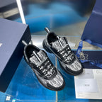 Two lace-up sneakers, silver logo-print uppers with black trims and thick rubber soles