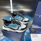 Pair of Dior unisex sneakers with black uppers, white panels, and light blue details