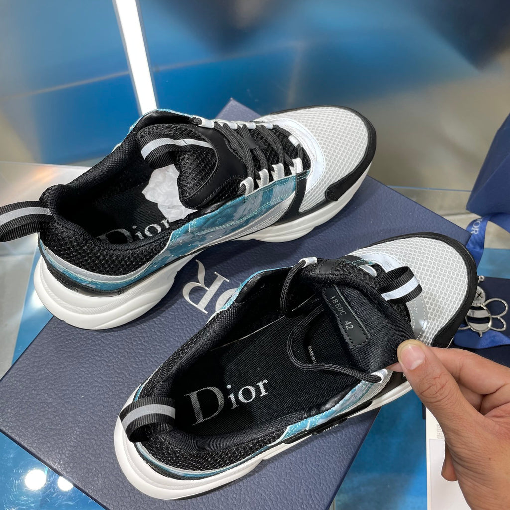Dior unisex sneakers with black heel and mesh panels, white sole, light blue side stripe
