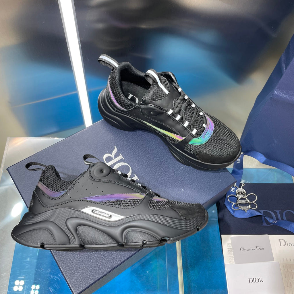 Black lace-up sneakers with mesh panels, chunky sole, and teal accent stripe