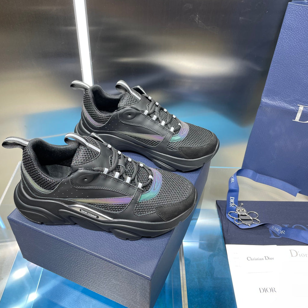Pair of black mesh lace-up sneakers with chunky sole and teal side stripe