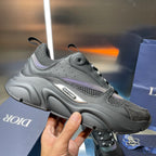 Gray black lace-up sneaker with textured panels, sculpted sole, and teal stripe