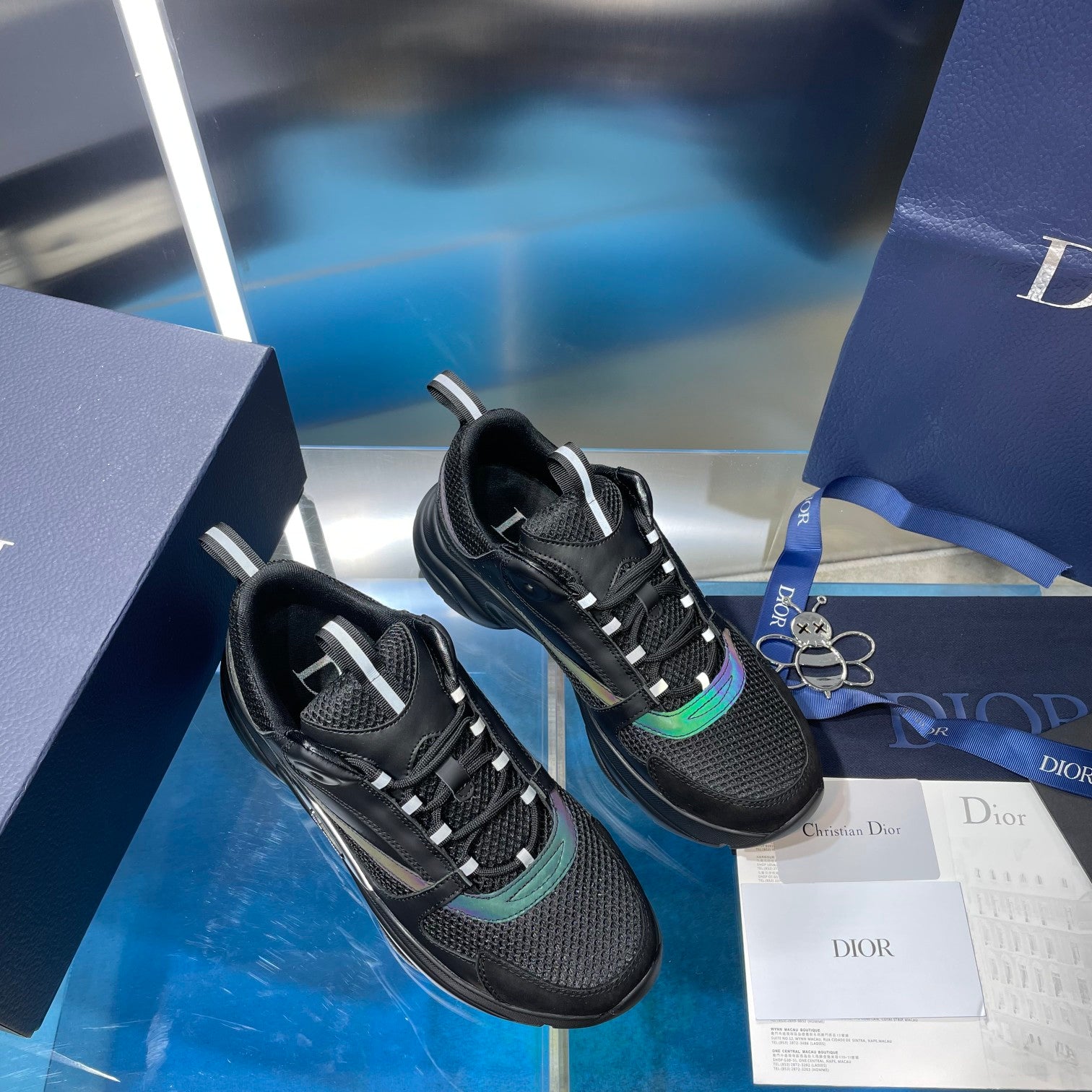 Black lace-up sneakers on a pair with teal accent trim and padded tongues