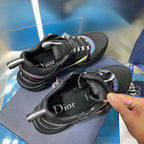 Black lace-up sneakers with visible Dior text on tongue and teal side trim