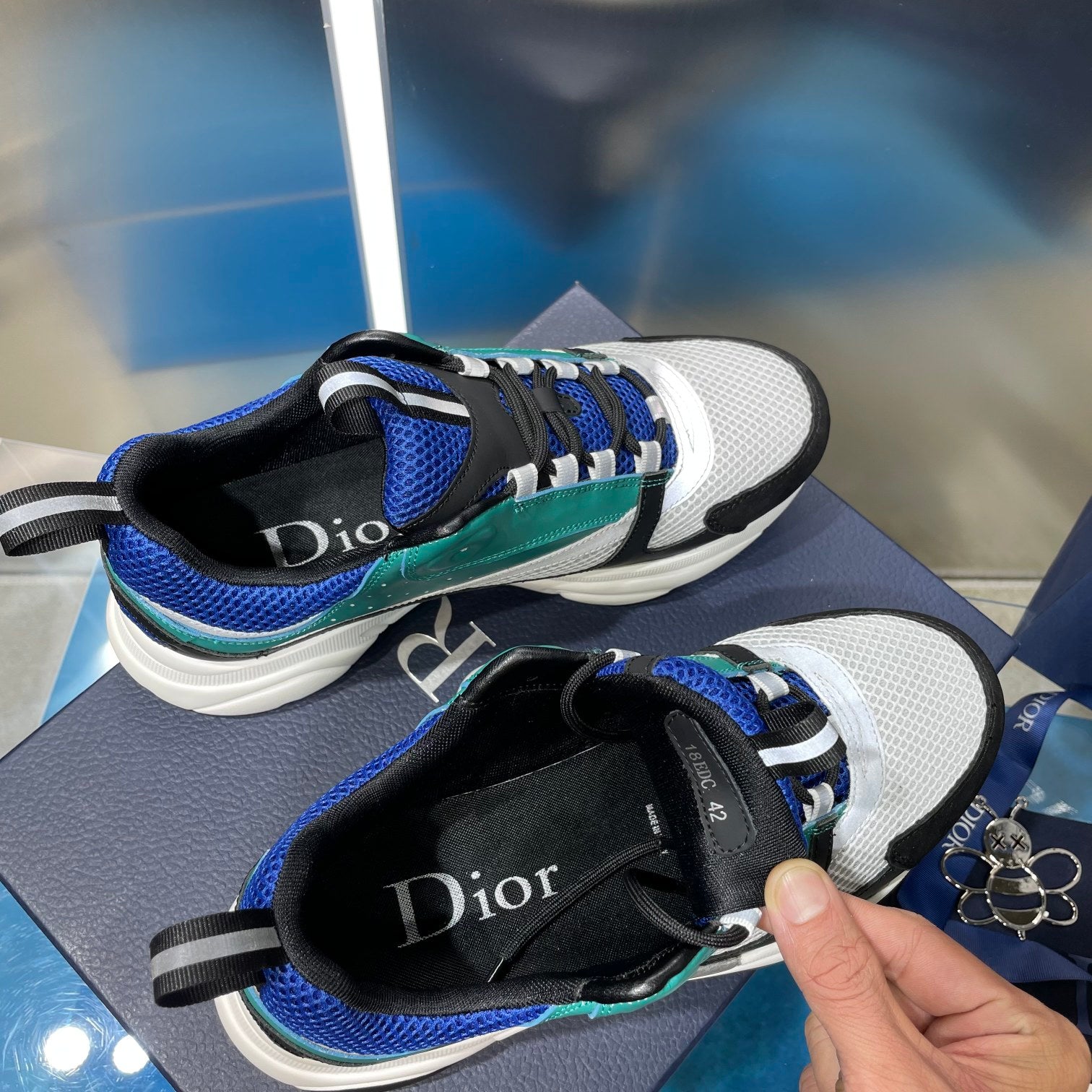 Dior unisex sneakers with adjustable strap and teal/blue mesh panels, white sole
