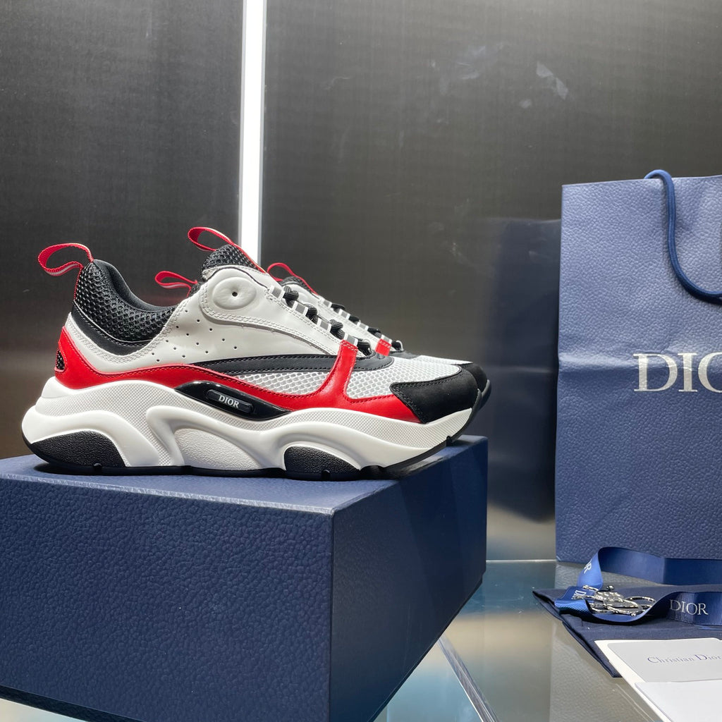 White and black lace-up sneakers with red accents and cushioned chunky midsole.