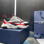 White and black lace-up sneakers with red accents and cushioned chunky midsole.