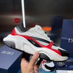 White and black sneakers with red side panel and chunky treaded outsole, side view.