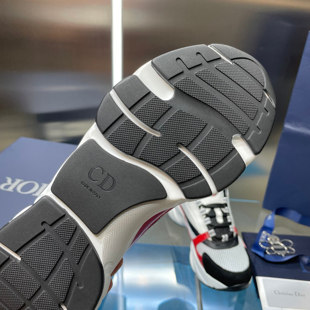 Sneaker outsole in dark rubber with textured traction, heel and forefoot tread.