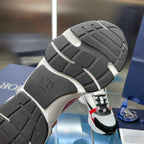 Sneaker outsole in dark rubber with textured traction, heel and forefoot tread.