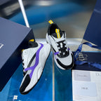 Dior chunky sneakers, black mesh and white panels with purple accents and yellow heel tabs