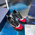 Unisex Dior lace-up sneakers pair, black uppers with red mesh toe and white stripes