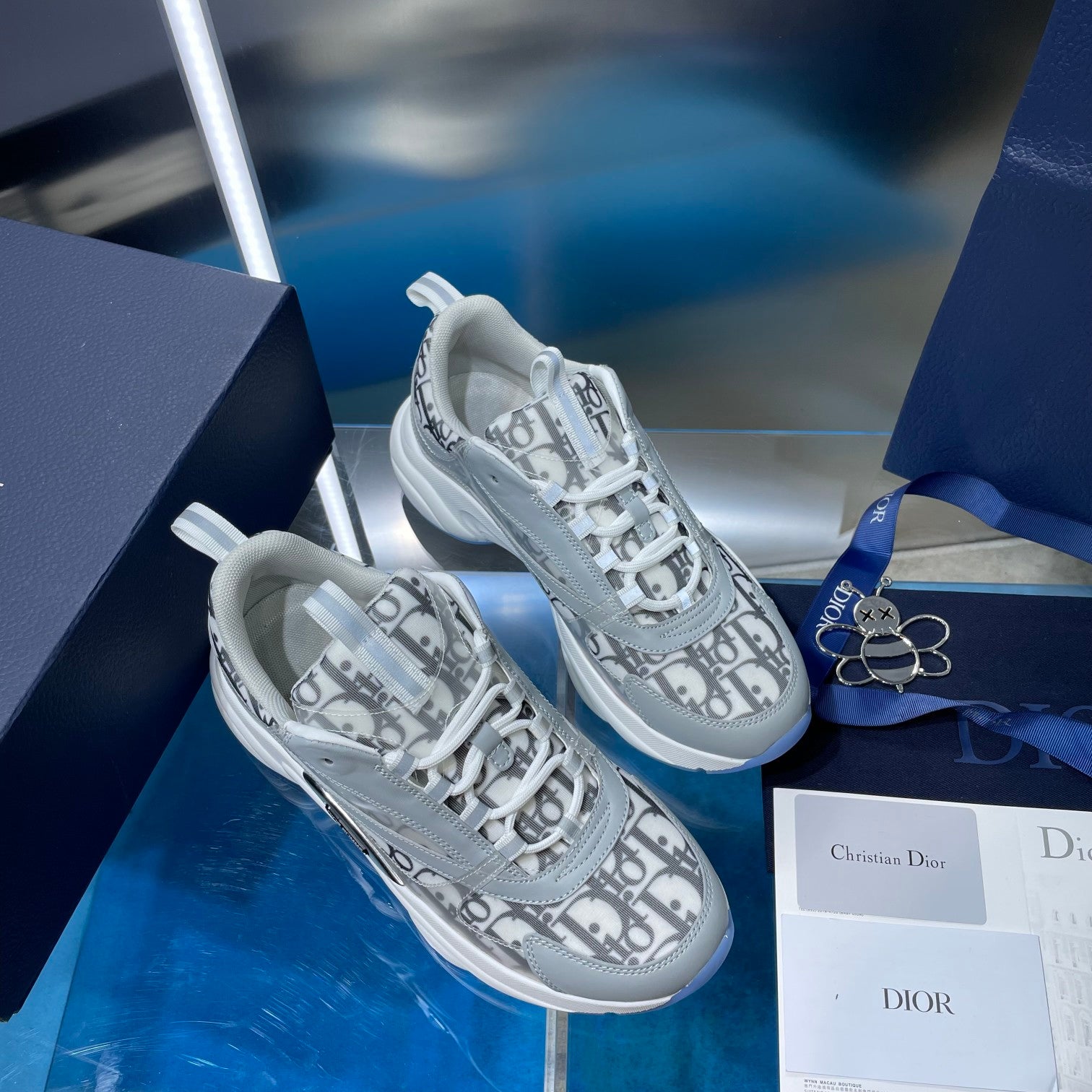 Dior unisex sneakers shown side-by-side with Dior Oblique print and white laces