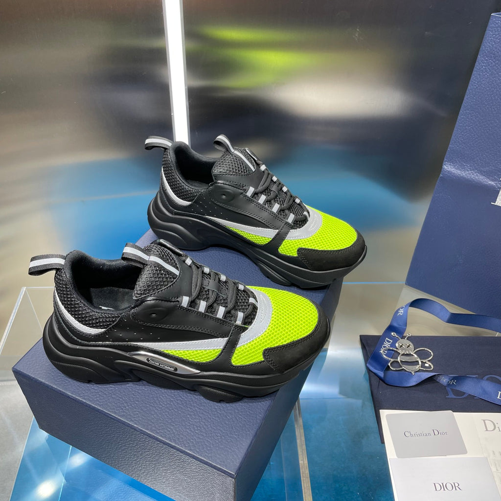 Pair of chunky lace-up sneakers: black and neon green with white midsole strip.