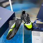 Side view of chunky sneakers in dark gray with neon green and black treaded sole.