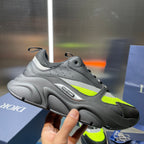 Chunky lace-up sneakers in light gray with neon green accents and rubber sole.