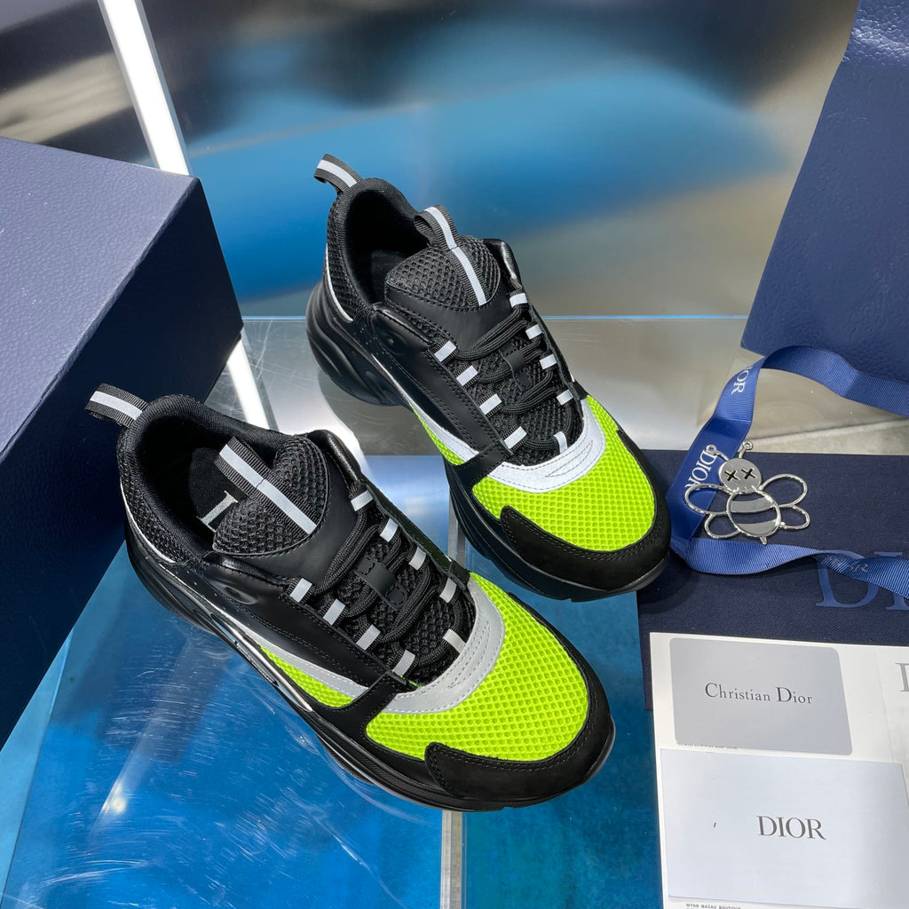 Two-tone chunky sneakers: black with neon green panels and white midsole details.