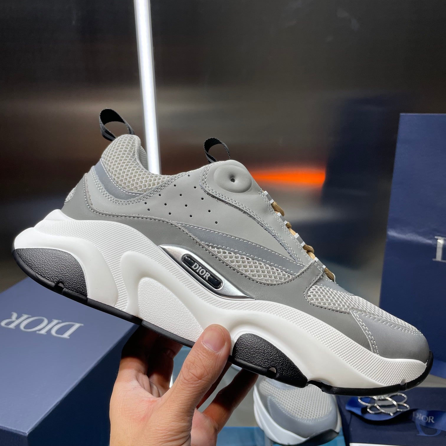 Unisex sneakers side view, light gray with black sole and gold lace trim