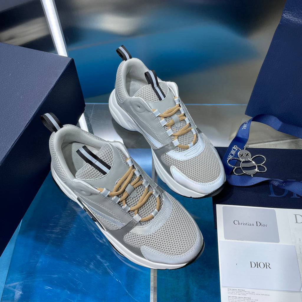 Unisex sneakers on box, light gray mesh, gold laces, and contrast heel tabs